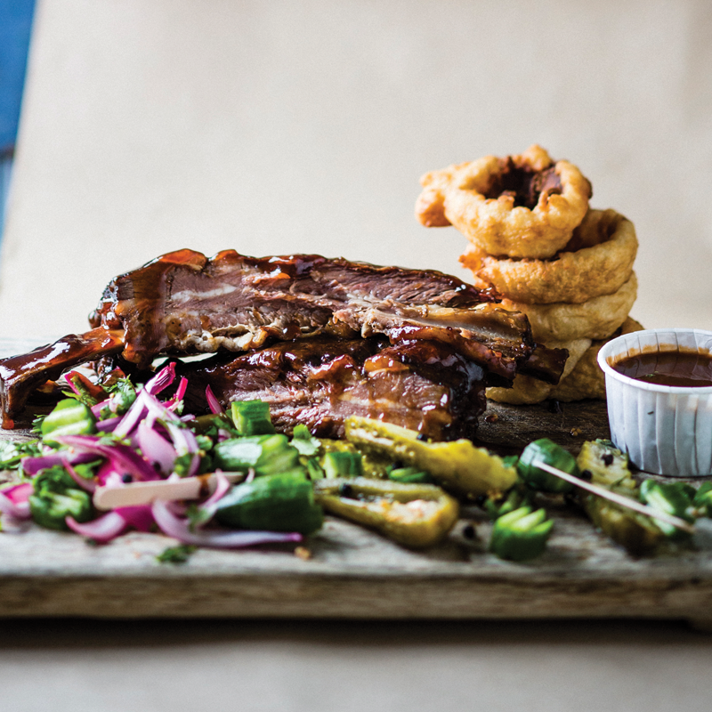 Smoked giant beef ribs with beerbattered onion rings and jalapeno