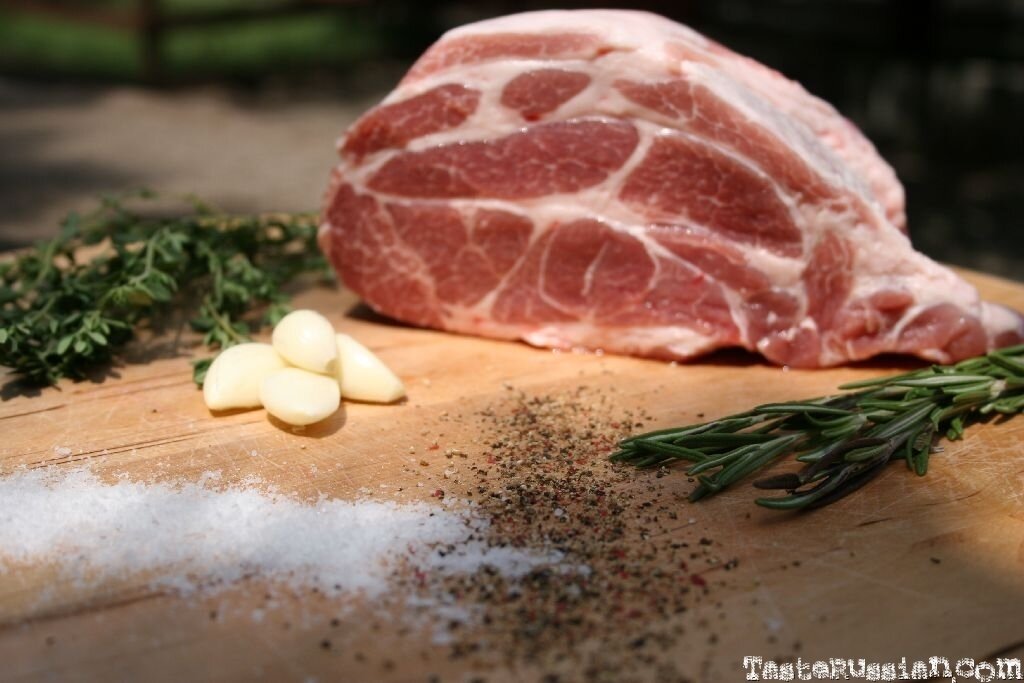 Meat with herbs and garlic in a baking sleeve