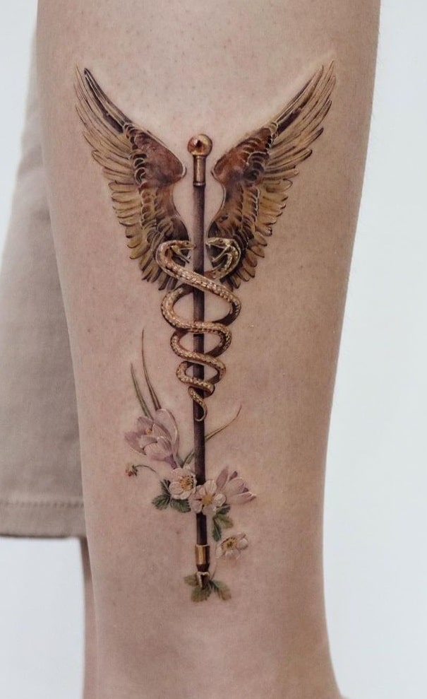 What Does A Snake Tattoo Symbolize? 989_x_605_jpg