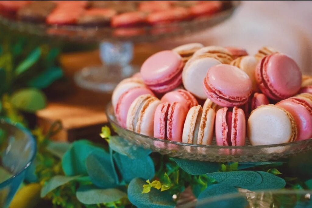 Different shades of pink macaroons sit in a bowl