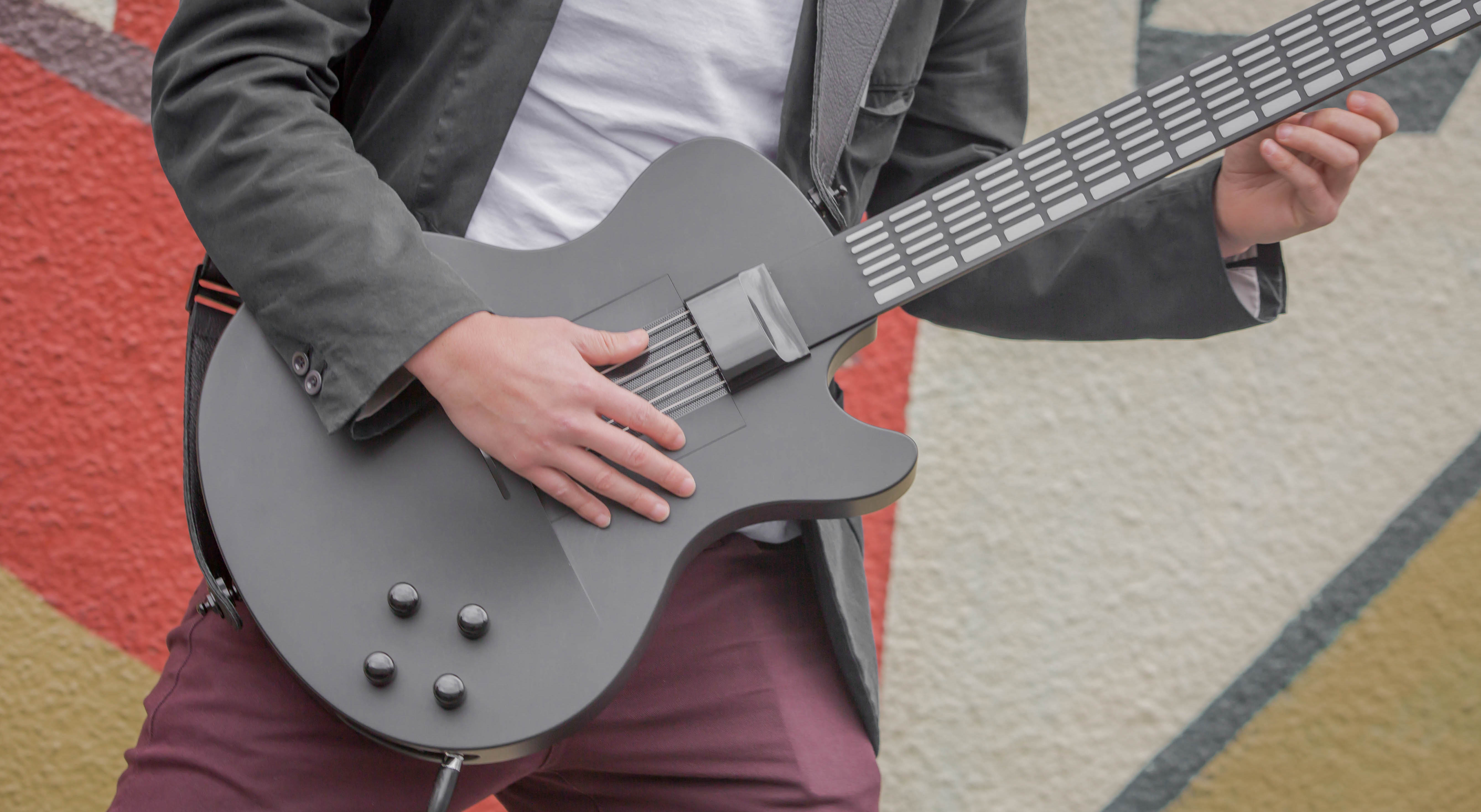 Press a button, play a chord on Magic Instruments’ digital guitar