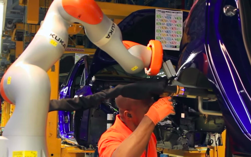 Ford shows how humans and robots work handinhand on its assembly line