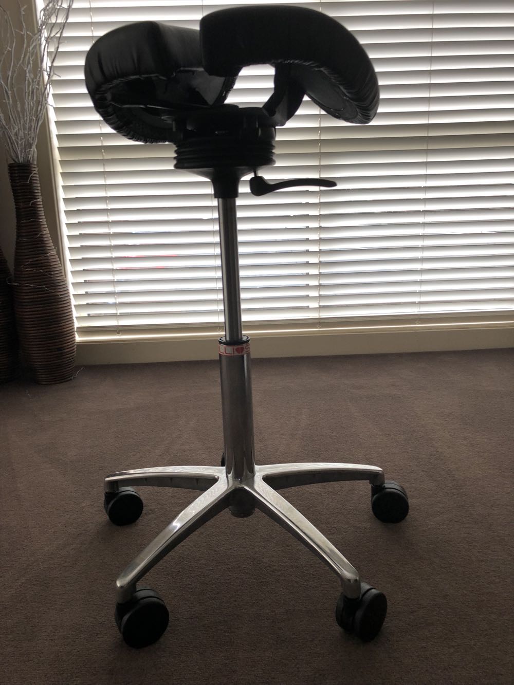 Salli Saddle Chair review combine sitting and standing to maintain a