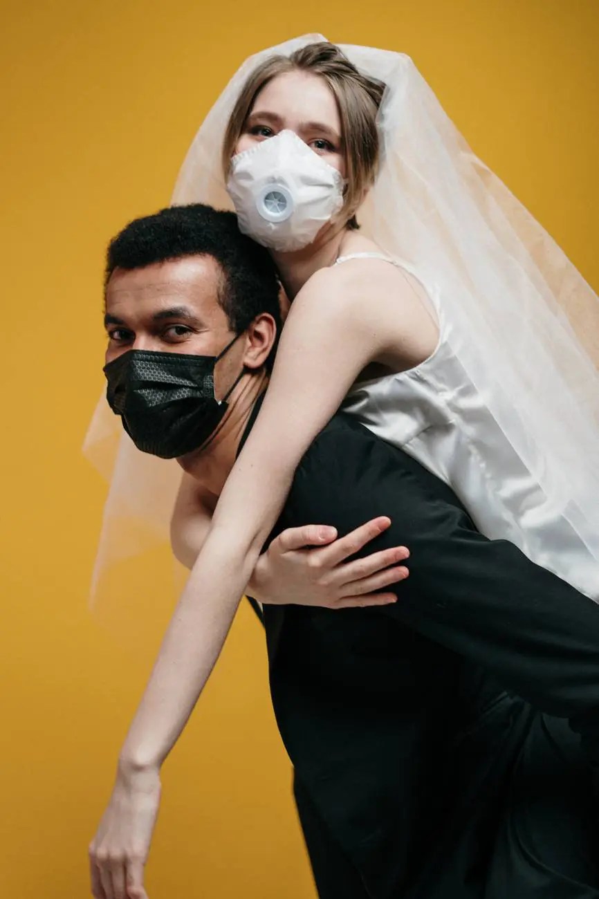man in black suit jacket and woman in white dress