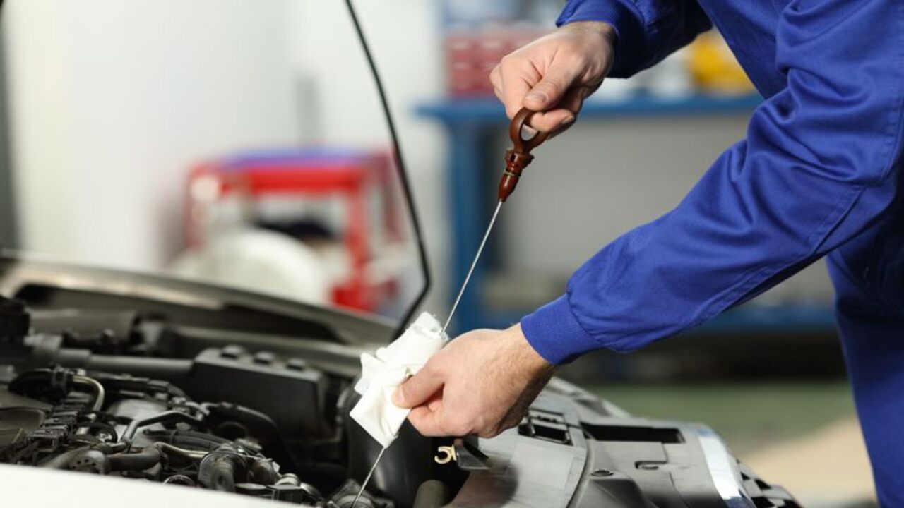 Reinserting And Removing The Dipstick To Check Oil Level