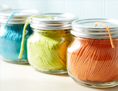 Using mason jars to organize your string in your craft room is a great idea.