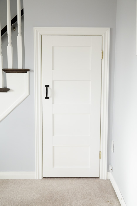 This simple white door with panels adds a cute farmhouse flair.