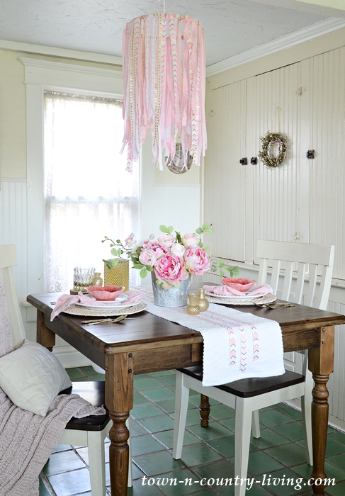 This ribbon chandelier looks great with this elegant tablescape for two