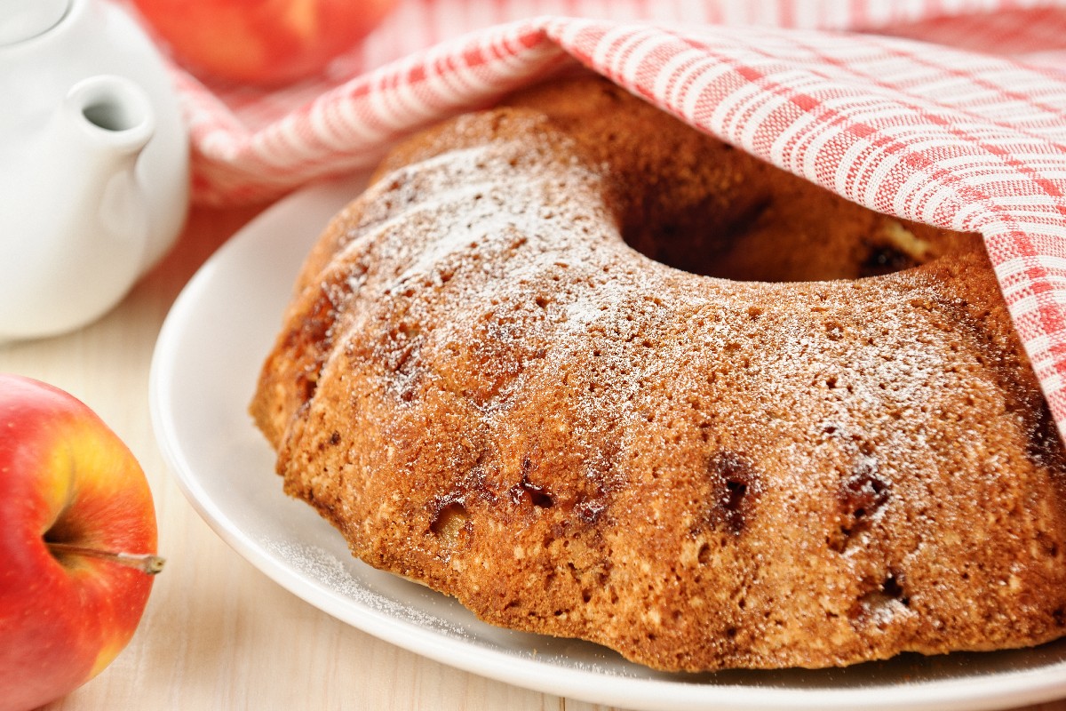 This apple cake dusted with powdered sugar is fresh and baked to perfection.