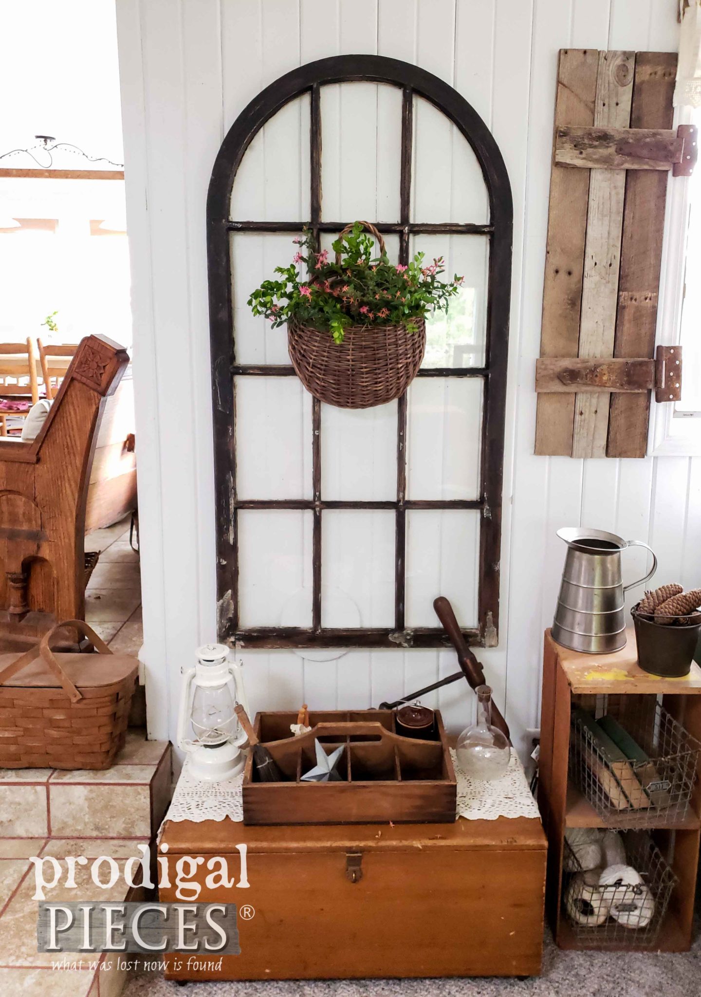 This antique window renovated with fresh flowers is a great farmhouse architectural piece.