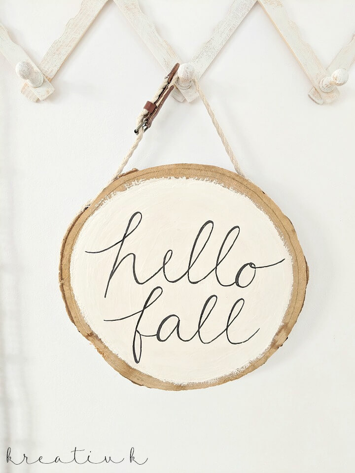 This DIY hello fall sign painted on a piece of wood is rustic for autumn.