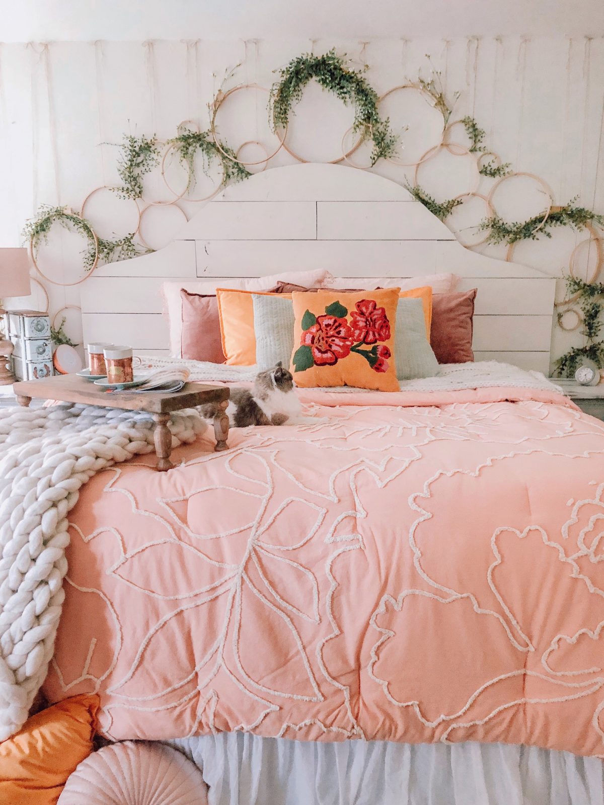 this bedroom is full of farmhouse style diys from the pallet headboard to the gorgeous hoop decor and wall detail