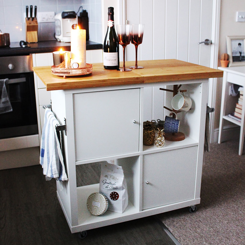 This Kitchen Island Hack was made with a Kallax and then put on wheels. Looks great... stores tons and a great working space!