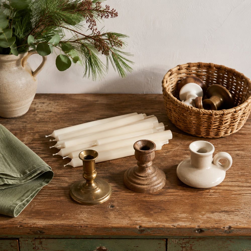Candles and candleholders organized during a home decor decluttering project