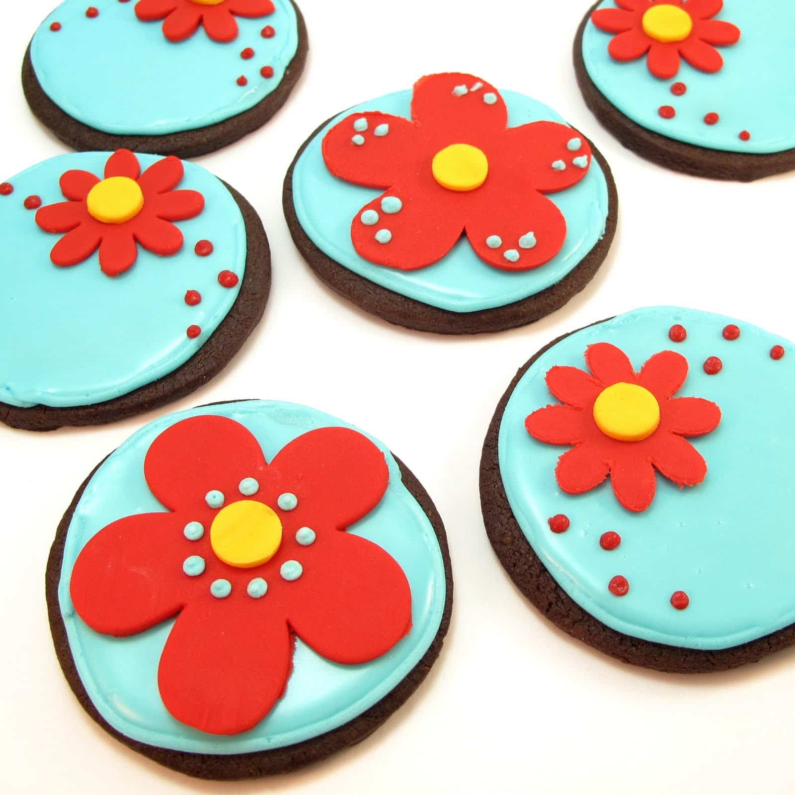 chocolate flower cookies with royal icing and fondant in