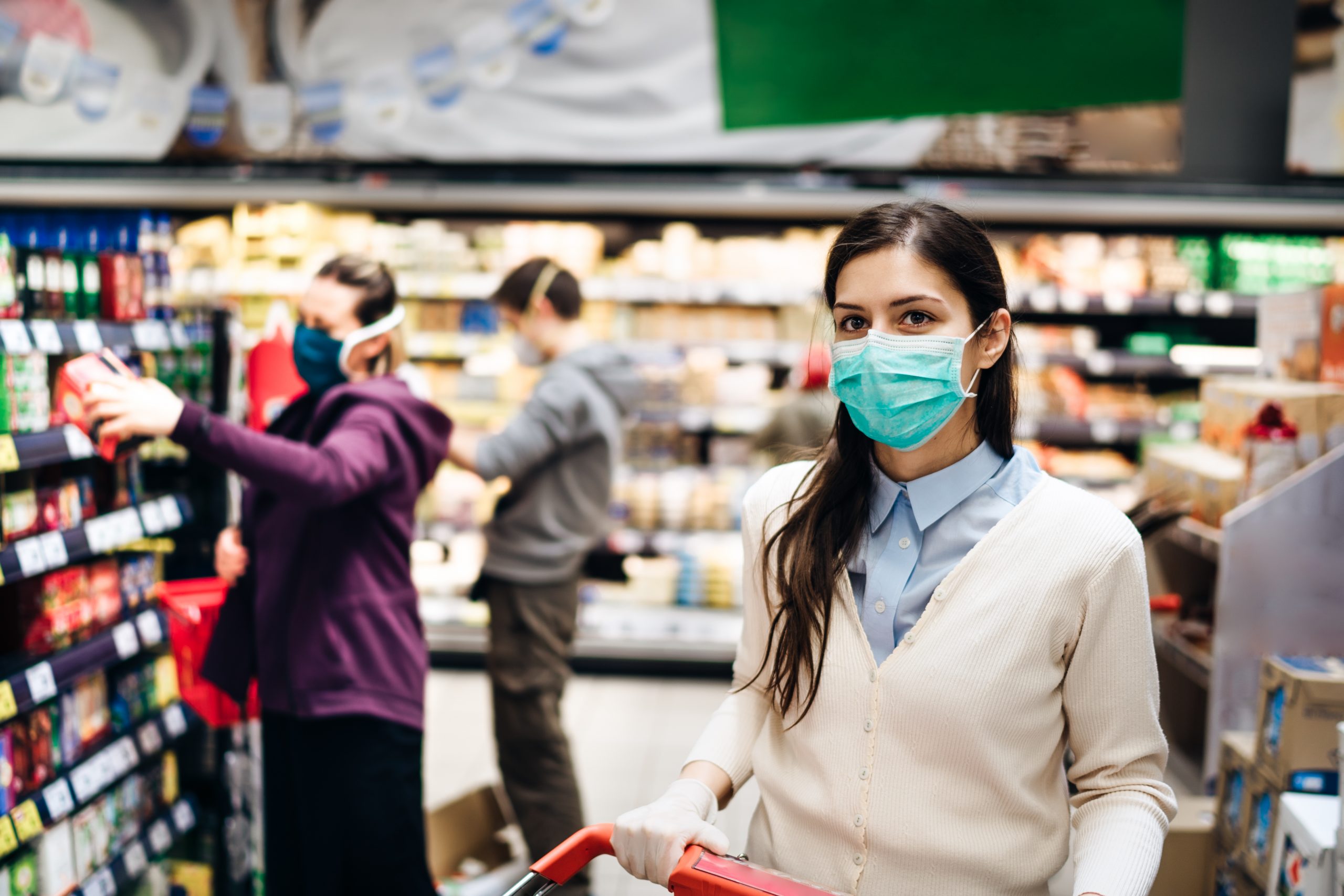 Shopper with mask safely buying for groceries due to coronavirus
