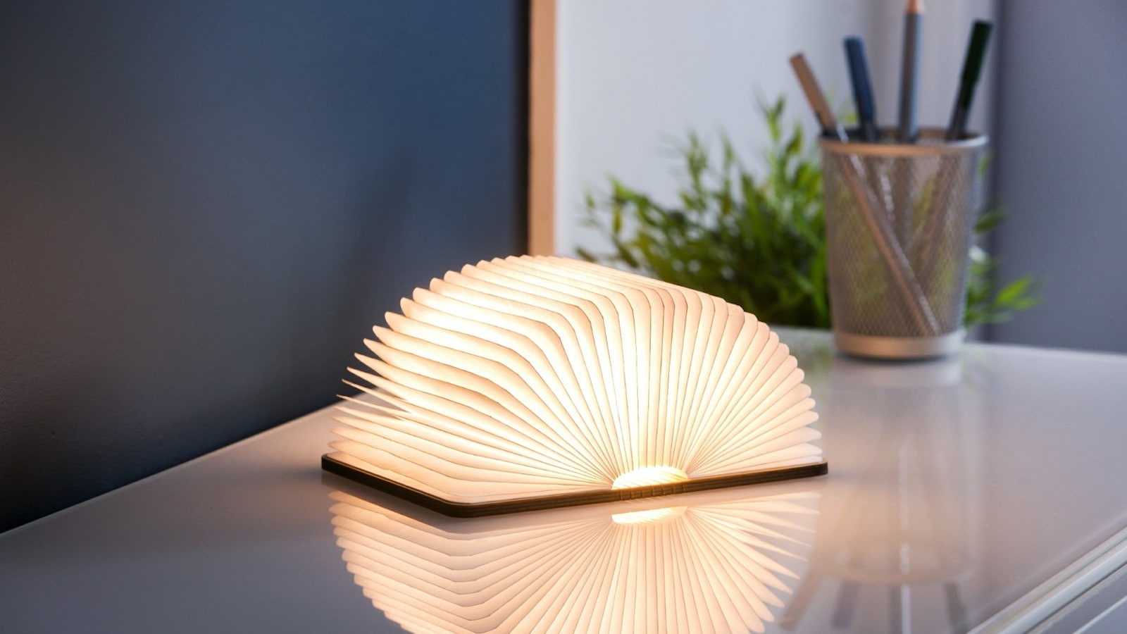 Gingko Smart Book Light transforms from a wooden book to a sculptural