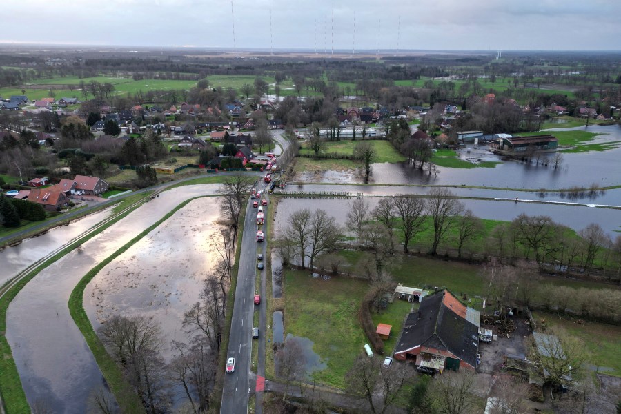 Towns reinforce dikes as heavy rains send rivers over their banks in