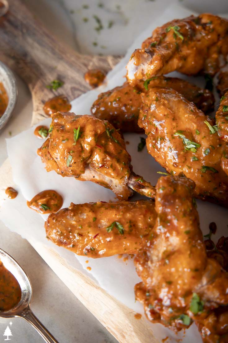These chipotle lime chicken wings are everything you love about classic wings, with an unexpected sucker-punch of southwestern flavors. #ketochipotlelimechickenwings #lowcarbchipotlelimechickenwings closer view of chipotle lime chicken wings on a platter