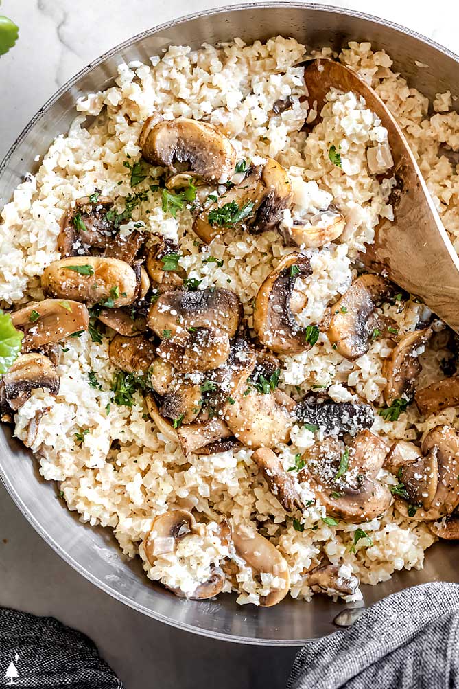 Mushrooms, garlic, and shallots bring the flavor in this buttery, creamy cauliflower risotto for a side dish you'll want to eat as your main! #cauliflowerrisotto #lowcarbcauliflowerrisotto closer view of cauliflower rice risotto