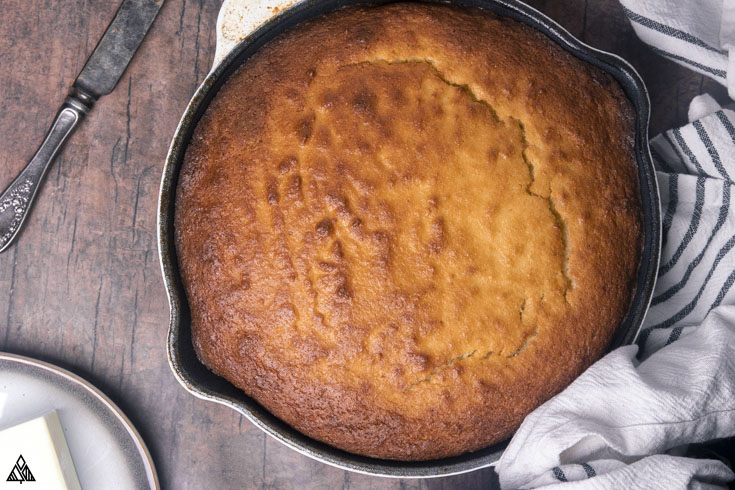 Soft, moist, fluffy, and buttery, with crispy edges, this LEGIT low carb cornbread is begging to be served warm with a slab-o-butter. #ketocornbread #lowcarbcornbread low carb cornbread in a pan