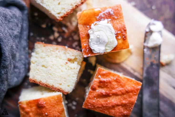 Soft, moist, fluffy, and buttery, with crispy edges, this LEGIT low carb cornbread is begging to be served warm with a slab-o-butter. #ketocornbread #lowcarbcornbread closer look of low carb cornbread