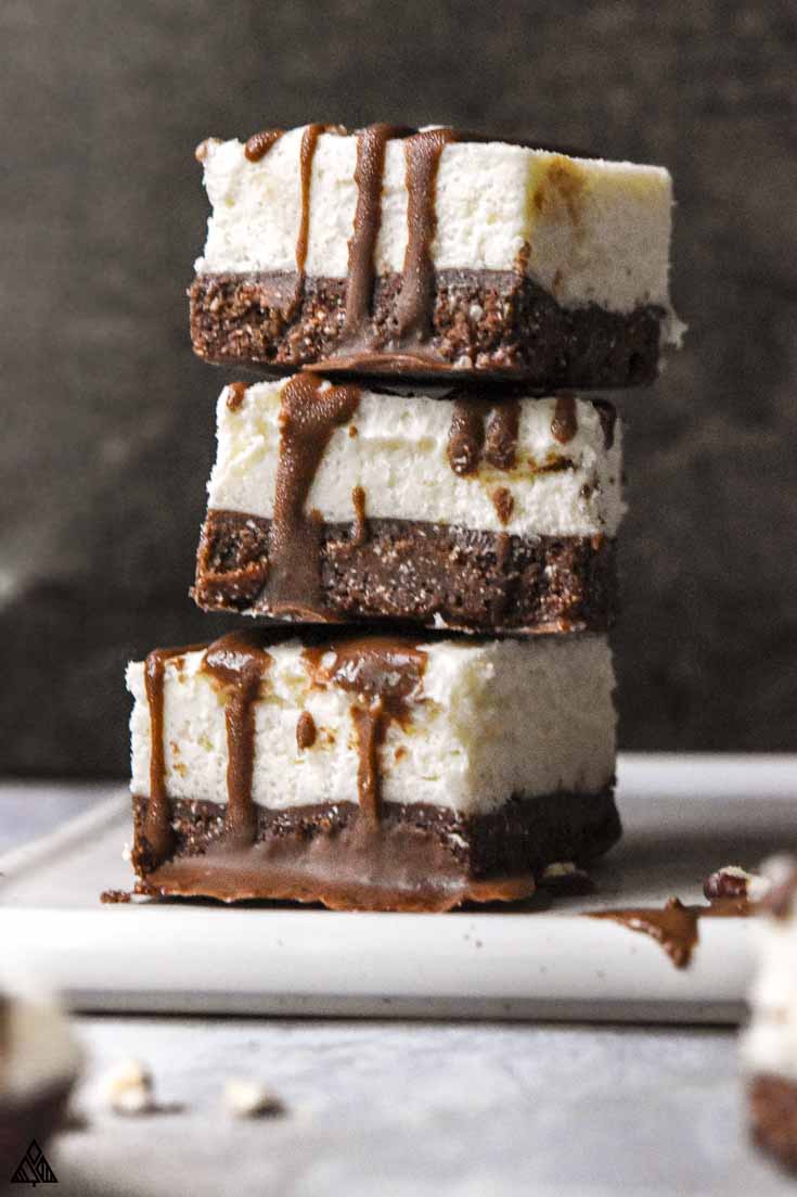 Decadent dreamy rich and creamy cheesecake fat bombs are simple wholesome nutrition that taste like dessert. #lowcarbcheesecakefatbombs #cheesecakefatbombs Stack of cheesecake fat bombs