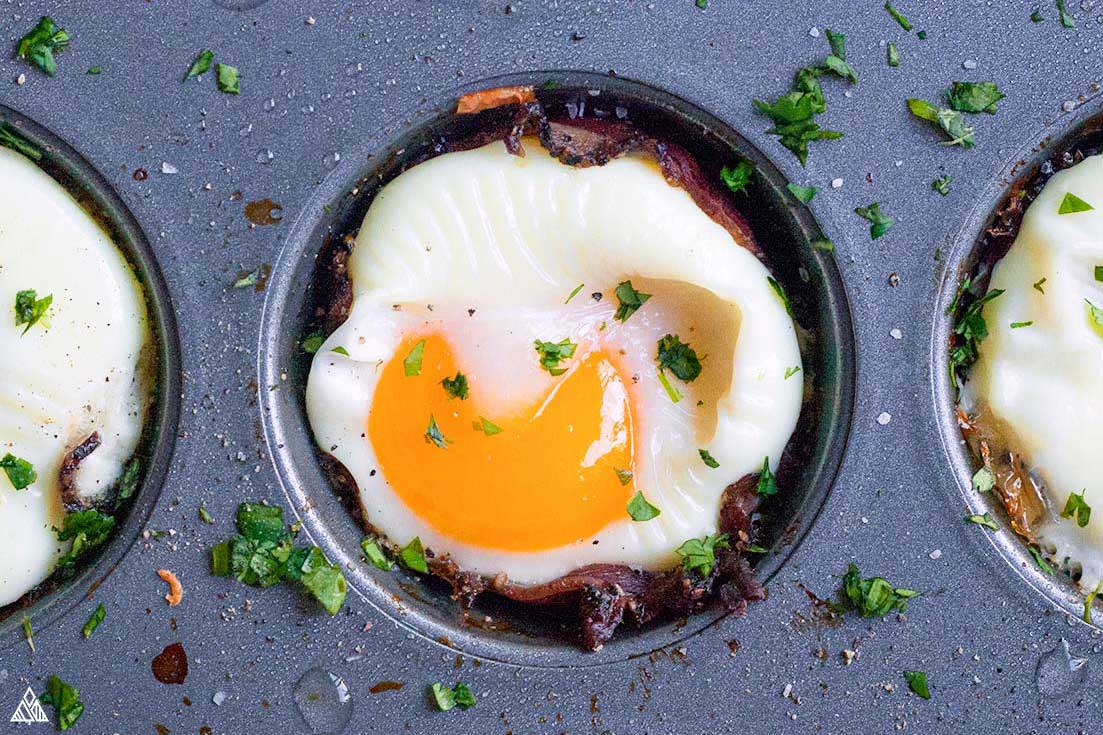 Waking up is hard, so when I want a week of easy, breezy mornings I whip up a batch of these dreamy 30 minute keto breakfast muffins! #lowcarbbreakfastmuffins #ketobreakfastmuffins Closer look of low carb breakfast muffins in a muffin tin