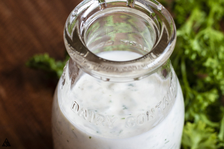 Looking for the GREATEST homemade ranch dressing recipe on the net?! The best part, it also just happens to be low carb! You’re going to want to dress it all! #homemaderanchdressing #lowcarbhomemaderanchdressing Closer look of homemade ranch dressing in a jar