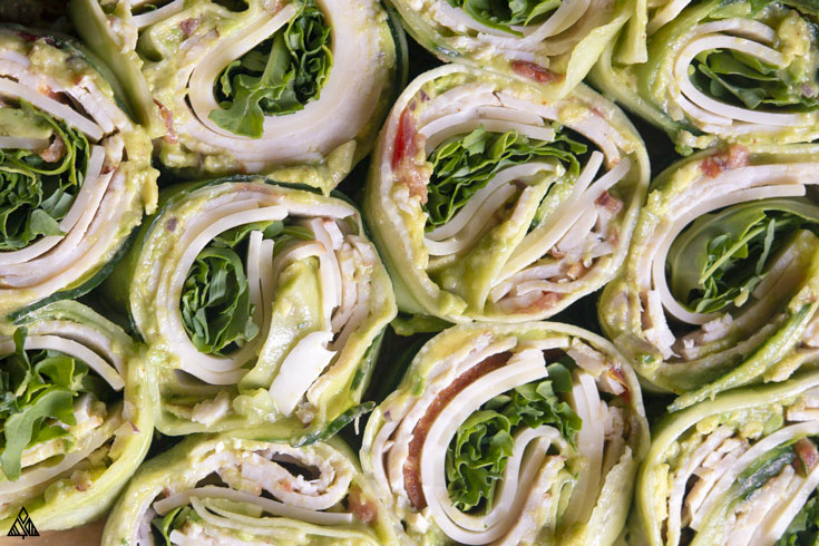 *NEW* These cucumber wraps make for the perfect low carb and paleo lunch or snack! Add your favorite wrap ingredients and roll away! #cucumberwraps #lowcarbcucumberwraps close up shot of cucumber wraps