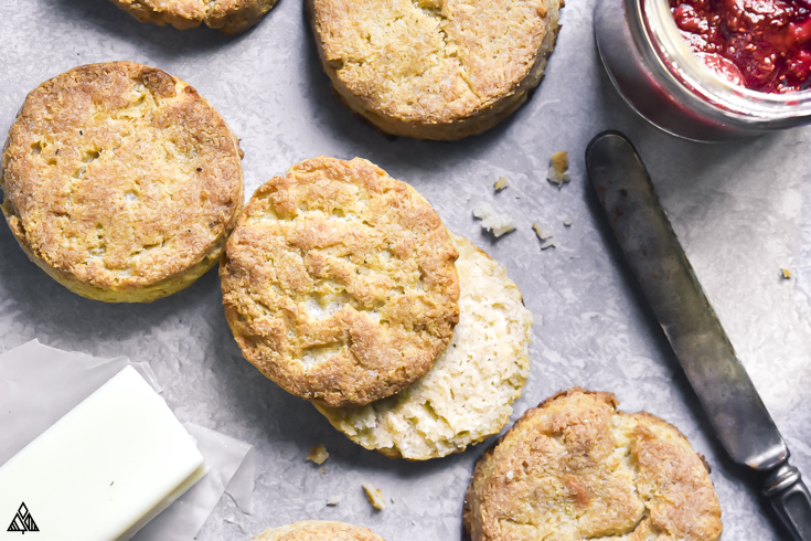 This homemade, buttery keto biscuits recipe is one to write home about. In fact, invite the whole family over to try them. #lowcarbbiscuits #ketobiscuits pile of low carb biscuits and butter