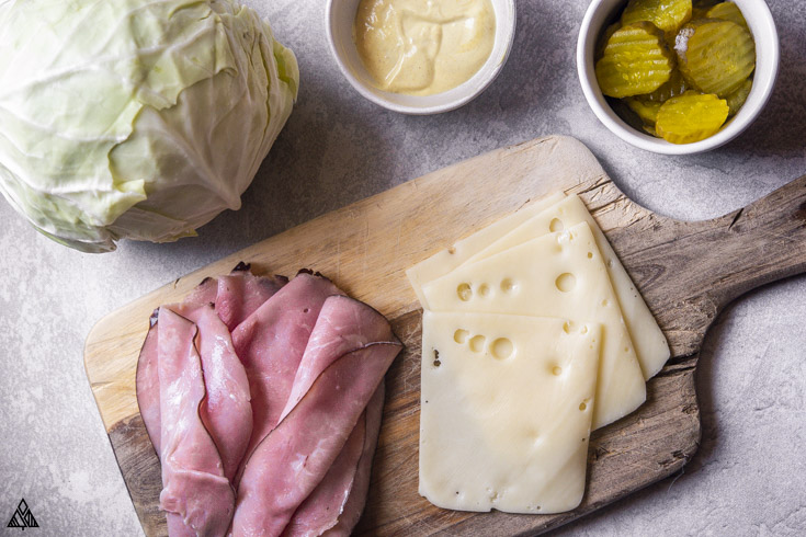 *NEW* Whether you're cutting your carbs, or just looking for healthier lunches, these Cubano cabbage wraps are the cheesiest most satiating meal! #cabbagewraps #ketocabbagewraps ingredients of cabbage wraps