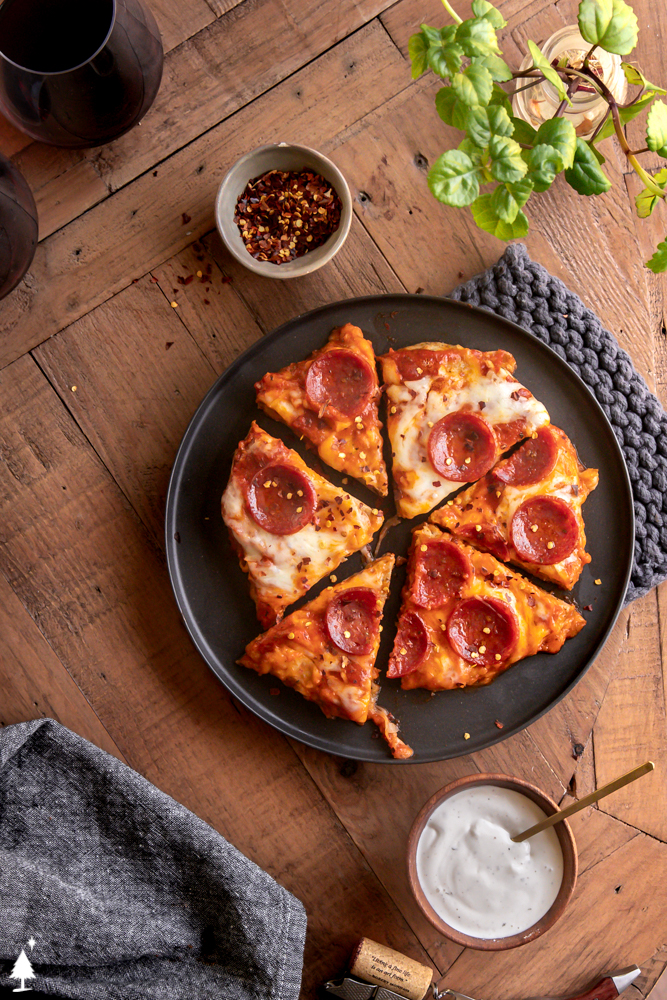 Get your pizza pizzazz on, with this juicy, flavor packed chicken crust pizza. It's an easy to make keto pizza you can EAT WITH YOUR HANDS! #ketochickencrustpizza #lowcarbchickencrustpizza top view of pizza chicken on a platter