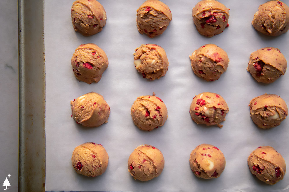 Bite-sized and built to satisfy, these white chocolate fat bombs are everything you're looking for in a treat. #ketowhitechocolatefatbombs #lowcarbwhitechocolatefatbombs White Chocolate Peanut Butter Fat Bombs on a baking sheet