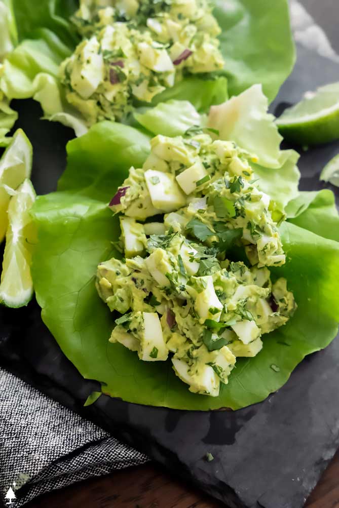 *NEW* (Believe it or not), this avocado egg salad is just as creamy as traditional egg salad, AND it's got a guacamole-inspired twist! #avocadoeggsalad #ketoavocadoeggsalad egg avocado salad in lettuce wraps