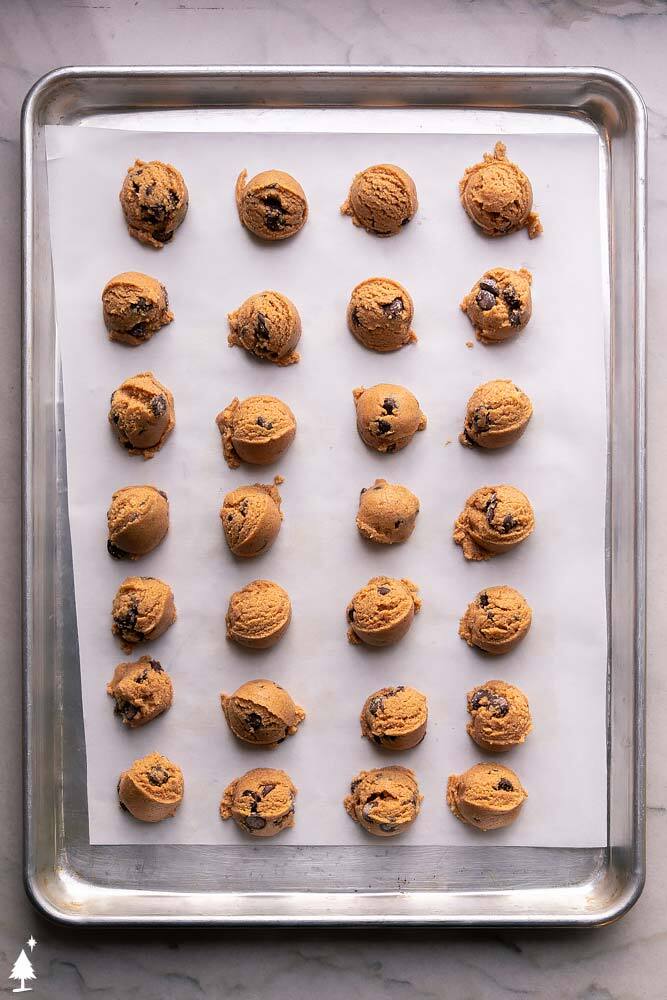 These cookie dough fat bombs are everything you LOVE in cookie dough, minus the eggs and carbs. Guilt free and totally delicious! #cookiedoughfatbombs #ketocookiedoughfatbombs cookie dough bites on a baking tray