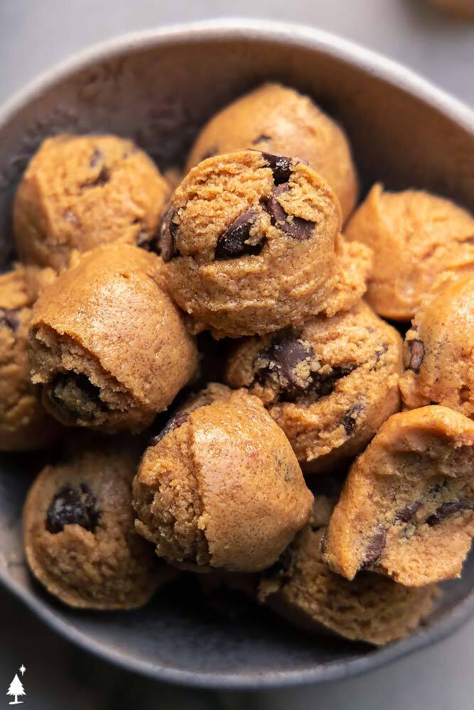 These cookie dough fat bombs are everything you LOVE in cookie dough, minus the eggs and carbs. Guilt free and totally delicious! #cookiedoughfatbombs #ketocookiedoughfatbombs top view of keto cookie dough bites in a bowl