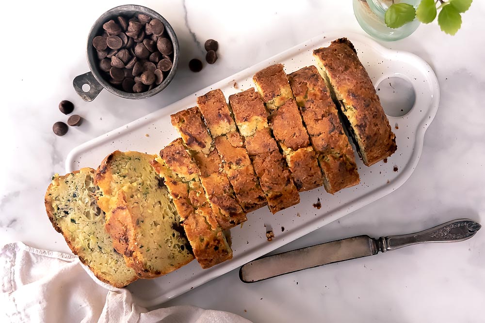 Sweet, fluffy, super moist, and chocolatey, this low carb zucchini bread will make you love vegetables! #lowcarbzucchinibread #ketozucchinibread top view of sliced almond flour zucchini bread
