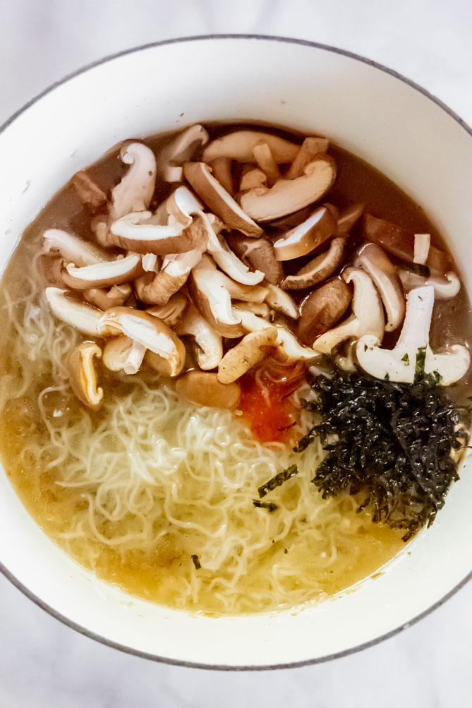 *NEW* I want this keto ramen to comfort you. Flavorful. Noodles. Jammy. Egg. This is not your every day low carb chicken soup. #ketoramen #lowcarbramen top view of keto ramen noodles ingredients