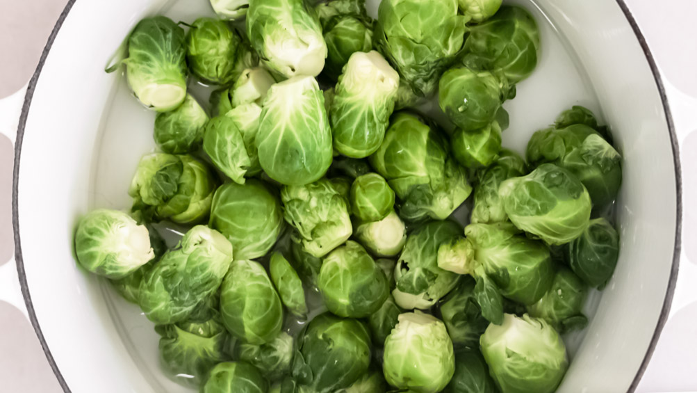 *NEW* Crispy baked parmesan cover these smashed brussels sprouts, for a tasty side dish that'll forever change the way you feel about this veggie! #smashedbrusselssprouts #lowcarbsmashedbrusselssprouts top view of smashed brussels sprouts with parmesan