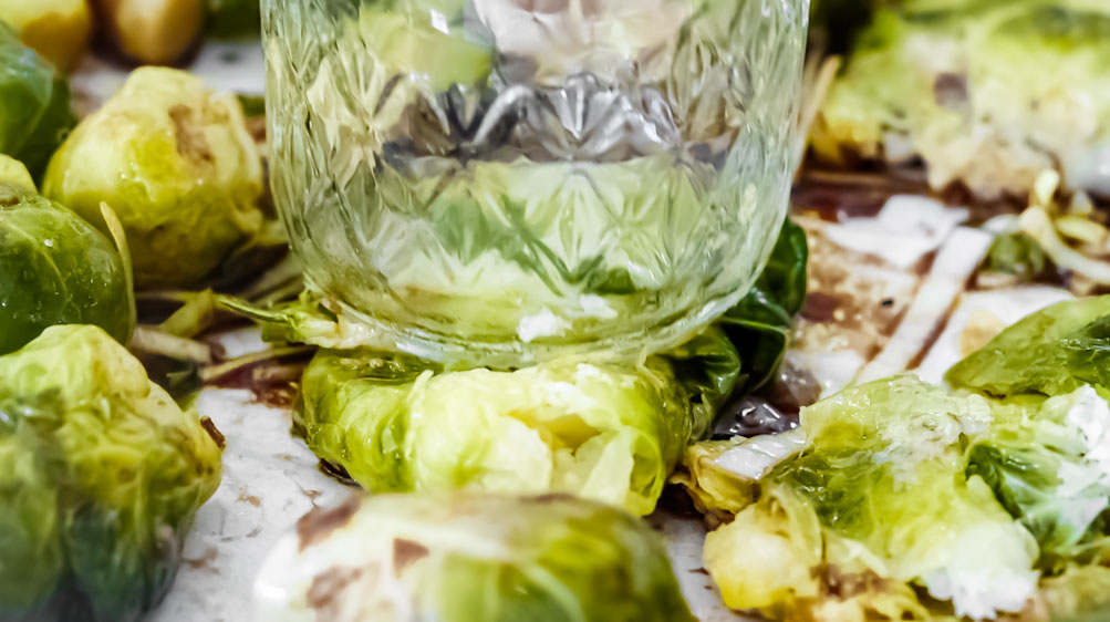 *NEW* Crispy baked parmesan cover these smashed brussels sprouts, for a tasty side dish that'll forever change the way you feel about this veggie! #smashedbrusselssprouts #lowcarbsmashedbrusselssprouts closer view of smashed brussels sprouts with parmesan