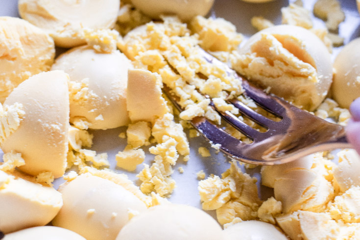 *NEW* Cheddar cheese, crispy bacon, fresh chives, and a zap of paprika - these bacon deviled eggs are perfect for snacks, apps + lunches! #ketodeviledeggs #lowcarbdeviledeggs top view of eggs for deviled eggs with bacon