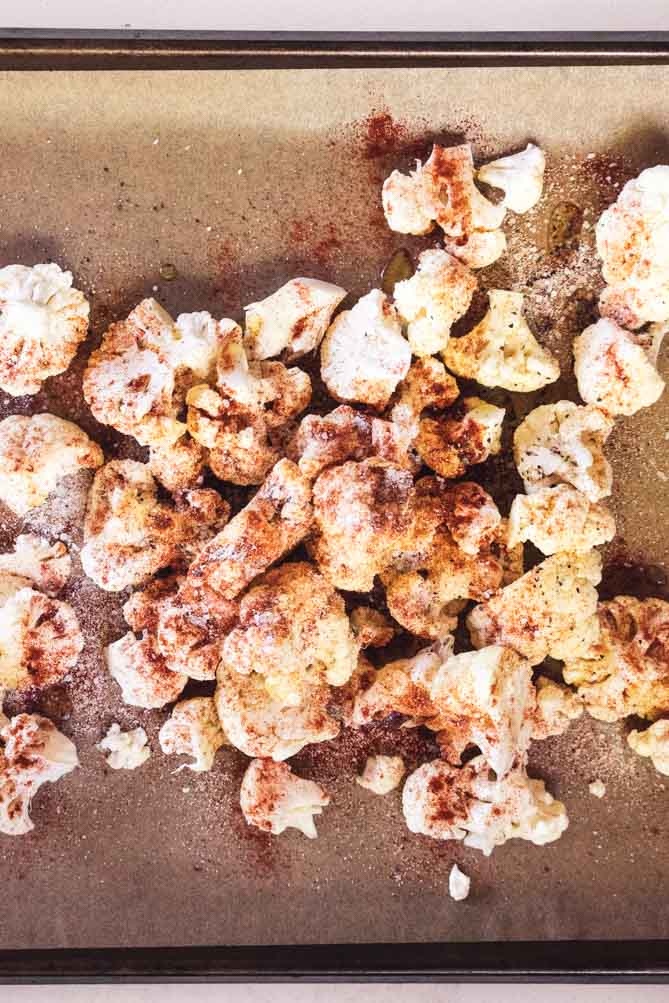 *NEW* Quick, easy, and deliciously seasoned, this roasted cauliflower is the perfect side dish to compliment any main--only five minutes of prep! #roastedcauliflower #lowcarbroastedcauliflower top view of roasted cauliflower recipe