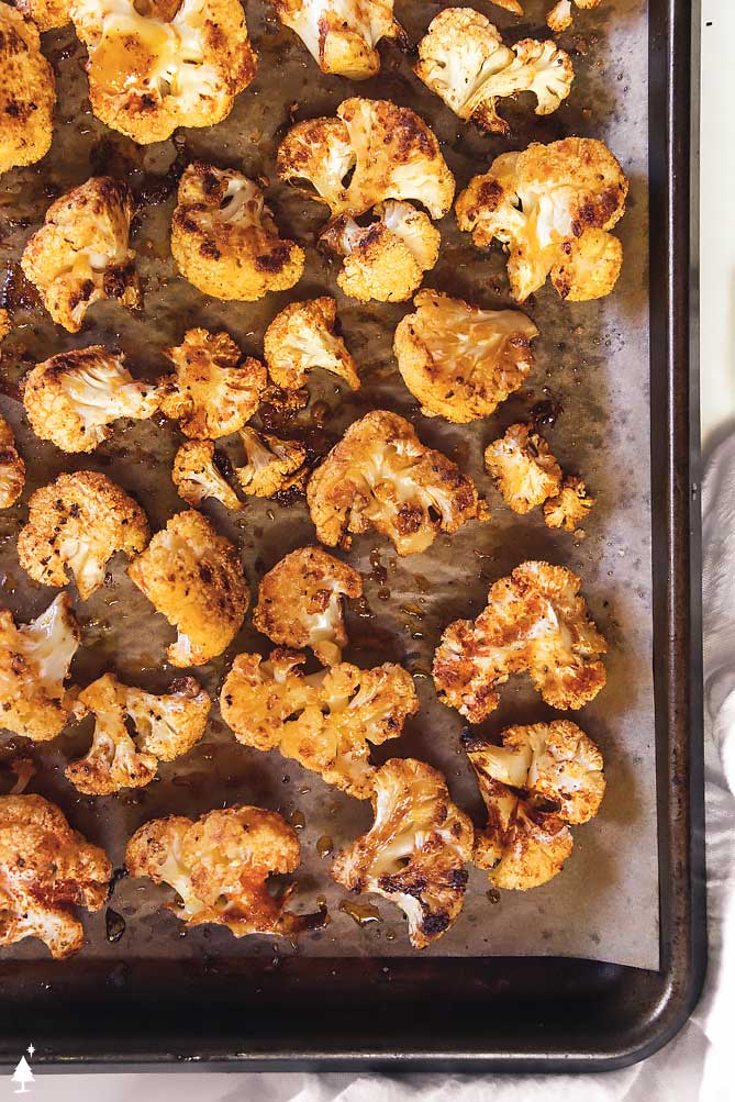 *NEW* Quick, easy, and deliciously seasoned, this roasted cauliflower is the perfect side dish to compliment any main--only five minutes of prep! #roastedcauliflower #lowcarbroastedcauliflower top view of roasted cauliflower recipe