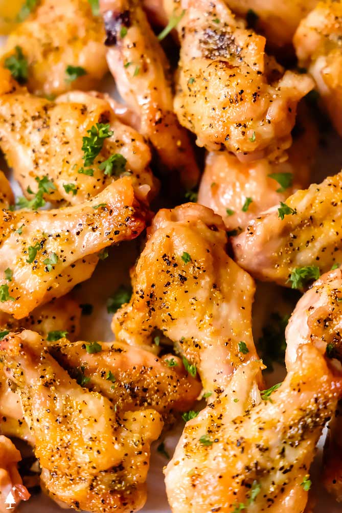 *NEW* Oven baked (or air fried!) to crispy perfection, these lemon pepper wings are salty, peppery, lemony, and oh-so delicious. #lemonpepperwings #lowcarblemonpepperwings closer view of lemon pepper chicken wings