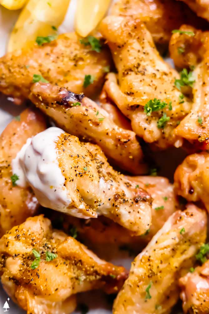 *NEW* Oven baked (or air fried!) to crispy perfection, these lemon pepper wings are salty, peppery, lemony, and oh-so delicious. #lemonpepperwings #lowcarblemonpepperwings closer view of lemon pepper chicken wings