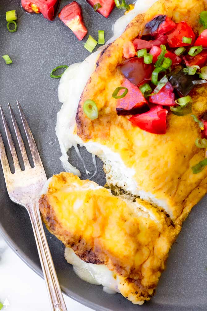 soufflé omelette on a plate with cheese strings