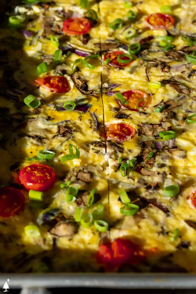 sheet pan eggs in oven with a spatula