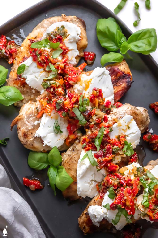 chicken bryan recipe on a black plate with basil
