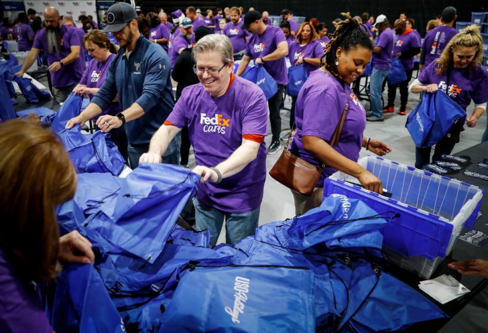 FedEx volunteers bundle 20,000 care packages for members of armed